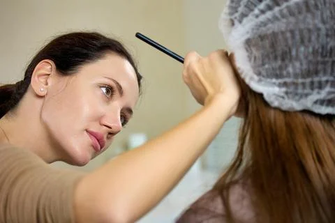 Process of preparing the client for the permanent makeup procedure Stock Photos