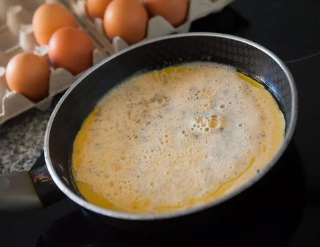 Process of preparing delicious appetizing omelet from chicken eggs Stock Photos