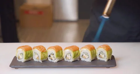 The process of preparing delicious sushi rolls with salmon and avocado. Chef Stock Footage 150398186