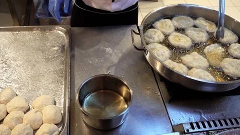 Process of preparing donuts from dough. Chef fry donuts in boiling oil. Stock Footage 105464189