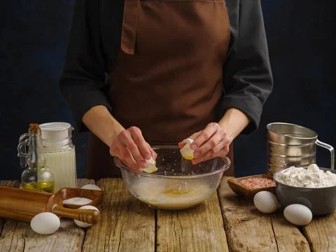 The process of preparing dough by a professional chef from ingredients laid o Stock Photos