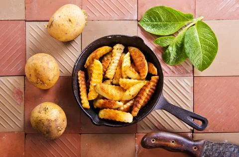 The process of preparing fried potatoes. Preparing a side dish for meat. Stock Photos