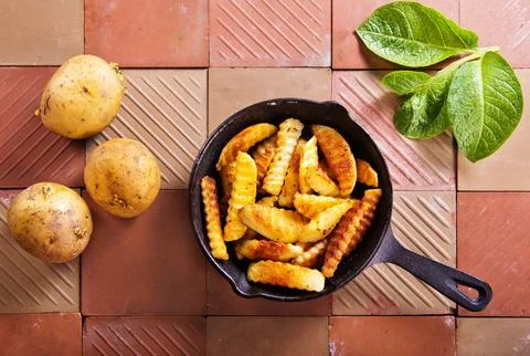 The process of preparing fried potatoes. Preparing a side dish for meat. Stock Photos