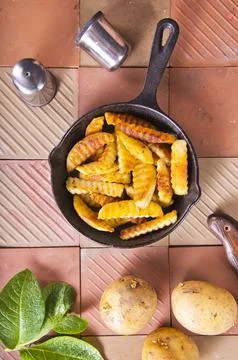 The process of preparing fried potatoes. Preparing a side dish for meat. Stock Photos