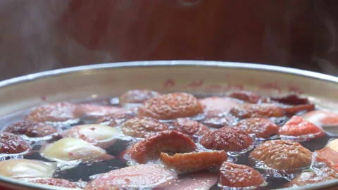 Process of preparing fruit drink. Fruit slices are boiled in boiling water, s Stock Footage 202044392