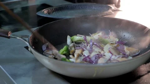 The process of preparing, frying fish and vegetables in the pan. Stock Footage 132412249