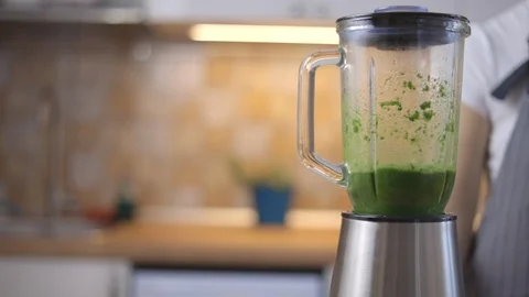The process of preparing green smoothie in a kitchen blender. Stock Footage 101276790