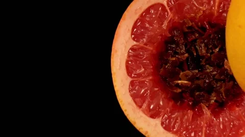 Process of preparing a hookah. Red grapefruit sliced in halves and stuffed with Stock Footage 149996679