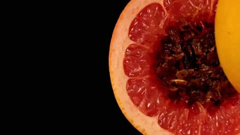 Process of preparing a hookah. Red grapefruit sliced in halves and stuffed with Stock Footage 151149020