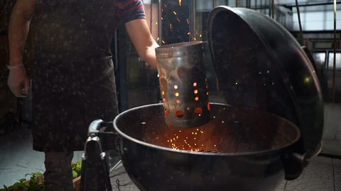 The process of preparing hot coal for a brazier grill outdoors Stock Footage 108758781