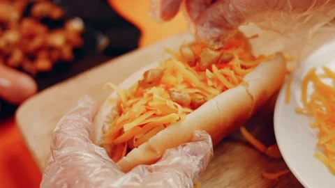 Process of preparing Irresistible chili cheese Hot Dogs. Taste USA cuisine witch Stock Footage 231548498