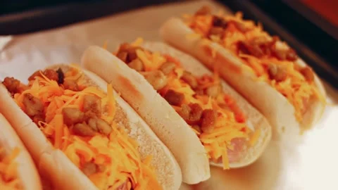 Process of preparing Irresistible chili cheese Hot Dogs. Taste USA cuisine witch Stock Footage 231549000