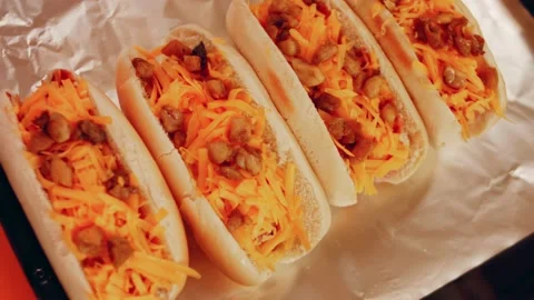 Process of preparing Irresistible chili cheese Hot Dogs. Taste USA cuisine witch Stock Footage 231549022