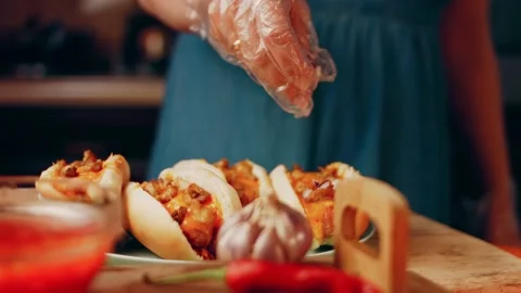 Process of preparing Irresistible chili cheese Hot Dogs. Taste USA cuisine witch Stock Footage 231549250