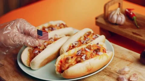 Process of preparing Irresistible chili cheese Hot Dogs. Taste USA cuisine witch Stock Footage 231549310