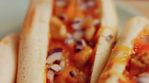 Process of preparing Irresistible chili cheese Hot Dogs. Taste USA cuisine witch Stock Footage 231549461