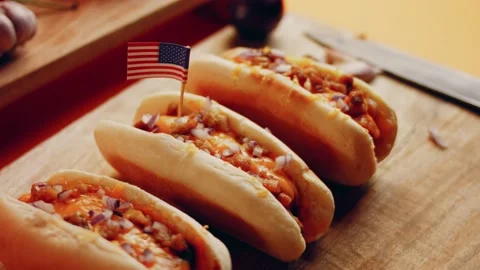 Process of preparing Irresistible chili cheese Hot Dogs. Taste USA cuisine witch Stock Footage 231549888