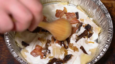 The process of preparing lasagna in an aluminum mold Stock Footage 248984146