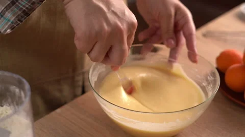 The process of preparing a liquid dough from eggs and flour, women's hands .. Stock Footage 341333200