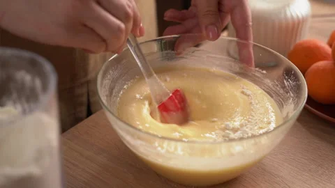 The process of preparing a liquid dough from eggs and flour, women's hands .. Stock Footage 341333905