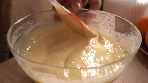 The process of preparing a liquid dough from eggs and flour, women's hands .. Stock Footage 341334345