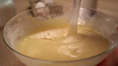 The process of preparing a liquid dough from eggs and flour, women's hands .. Stock Footage 341334821