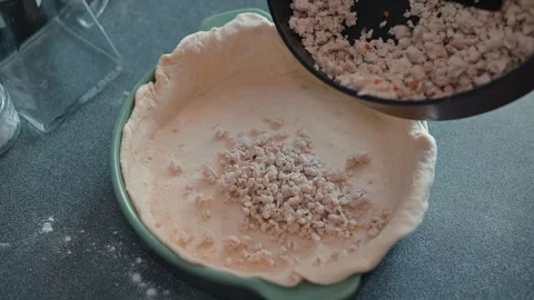 Process of preparing a meat pie crust followed by the addition of a filling. Stock Footage 339094495