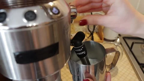 Process of preparing milk foam for cappuccino or latte in the pitcher Stock Footage 219735293