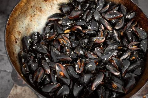 The process of preparing mussels in a large saucepan. Street food with seafoo Stock Photos