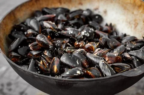 The process of preparing mussels in a large saucepan. Street food with seafoo Stock Photos