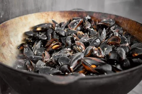 The process of preparing mussels in a large saucepan. Street food with seafoo Stock Photos