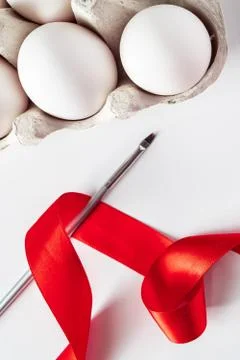 The process of preparing for painting eggs for Easter on a white background. Stock Photos