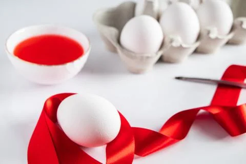 The process of preparing for painting eggs for Easter on a white background. Stock Photos