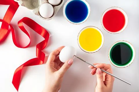 The process of preparing for painting eggs for Easter on a white background. Stock Photos