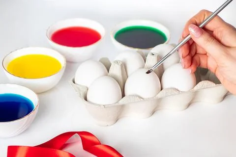 The process of preparing for painting eggs for Easter on a white background. Stock Photos