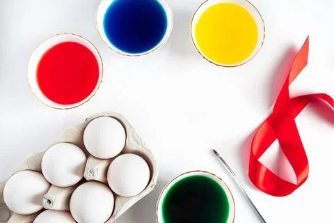 The process of preparing for painting eggs for Easter on a white background. Stock Photos