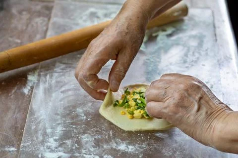 Process of preparing pelmeni with vegetable filling of onions and eggs on flo Stock Photos