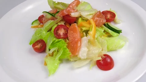 Process of preparing a salad with vegetables, adding lemon juice Stock Footage 84261097