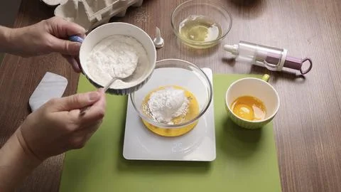 Process of preparing scales and utensils for making dough. Woman weighs flour Stock Photos