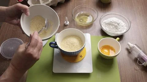 Process of preparing scales and utensils for making dough. Woman weighs products Stock Photos