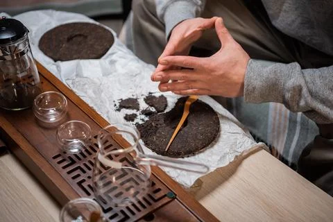The process of preparing for the tea ceremony is a major one. Men's hands break Stock Photos
