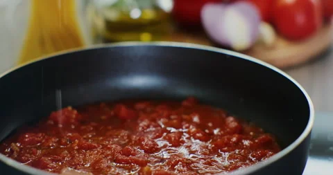 Process of preparing a tomato sauce in a hot pan, close-up. Fresh vegetables Stock Footage 171938432