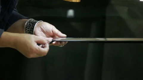 Process of preparing windshield for replacement in car service. A worker Stock Footage 227101814
