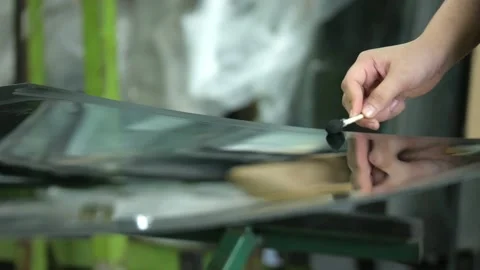 Process of preparing windshield for replacement in car service. A worker Stock Footage 227103441