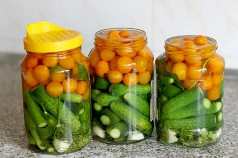The process of preserving cucumbers and tomatoes for the winter. selective fo Stock Photos