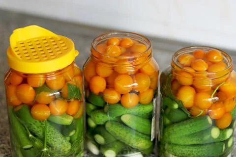 The process of preserving cucumbers and tomatoes for the winter. selective fo Stock Photos