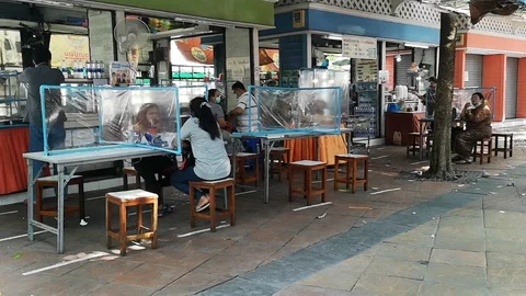 The process of preventing the spread of COVID-19 corona virus in streetfood r Stock Footage 129989481