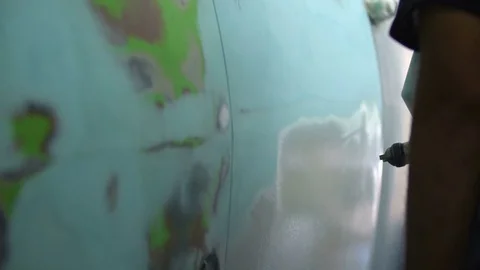 The process of priming the car before applying the paint. Car repair shop. Stock Footage 85073447