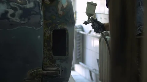 The process of priming the car before applying the paint. Car repair shop. Stock Footage 85073570