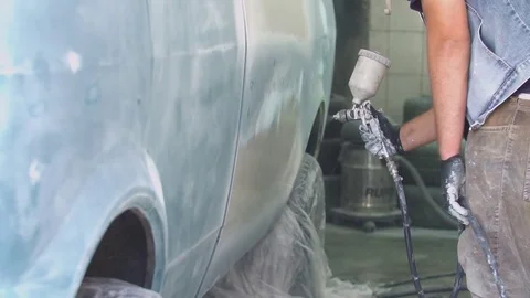 The process of priming the car before applying the paint. Car repair shop. Stock Footage 85074303